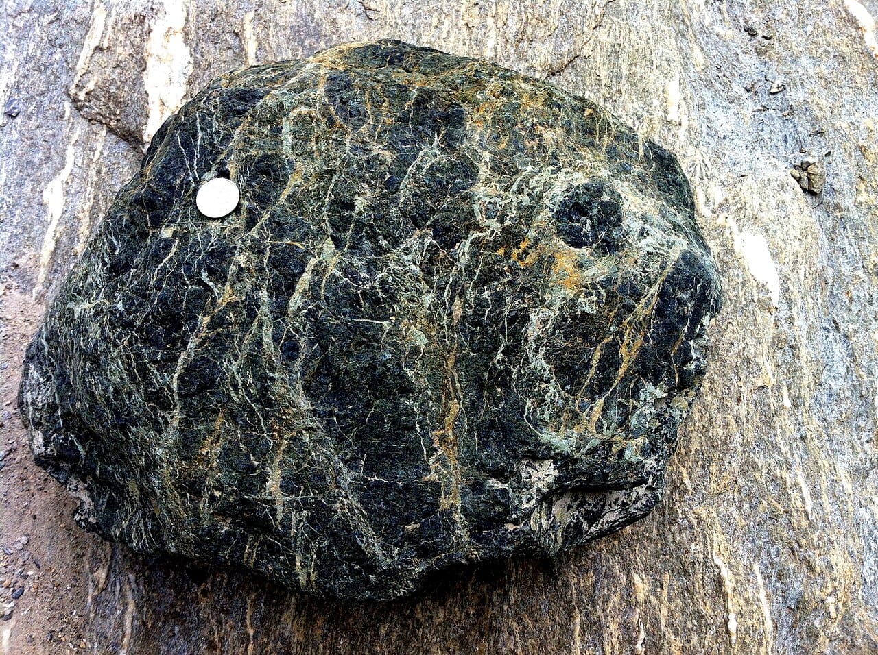 Serpentinite. Seawater reacting with mantle rock produces hydrogen and an alkaline fluid, and the reaction sustains itself for tens of thousands of years without volcanic heat.