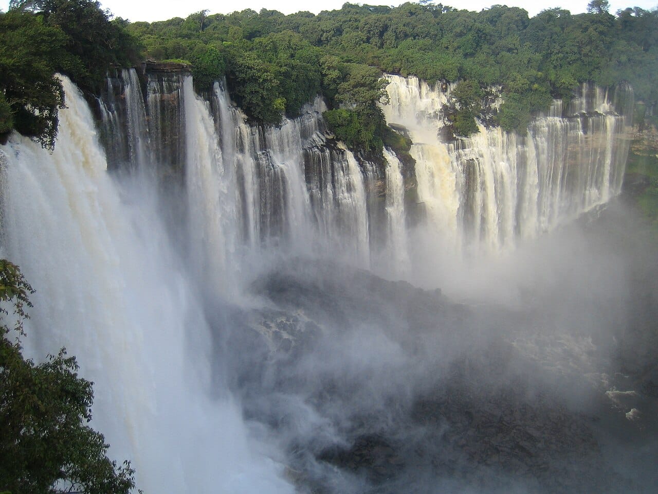 The Kalandula Falls on the Lucala River, among the largest waterfalls in Africa. Beyond its oil-rich coast, Angola holds a green and dramatic interior of highlands, rivers, and savanna, still little known to the outside world.