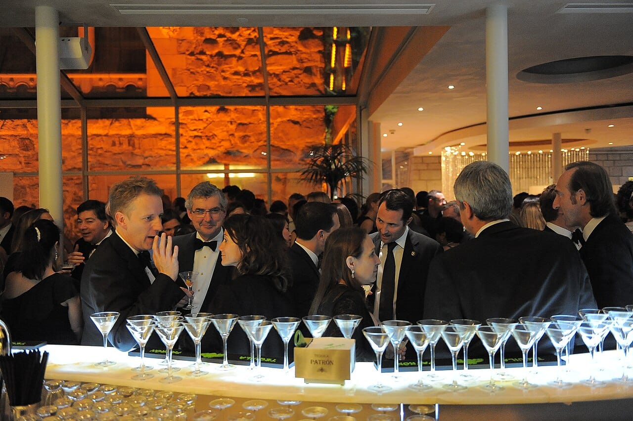 A crowded bar. Following one conversation while others continue nearby is the everyday version of the problem, and it gave the effect its name.