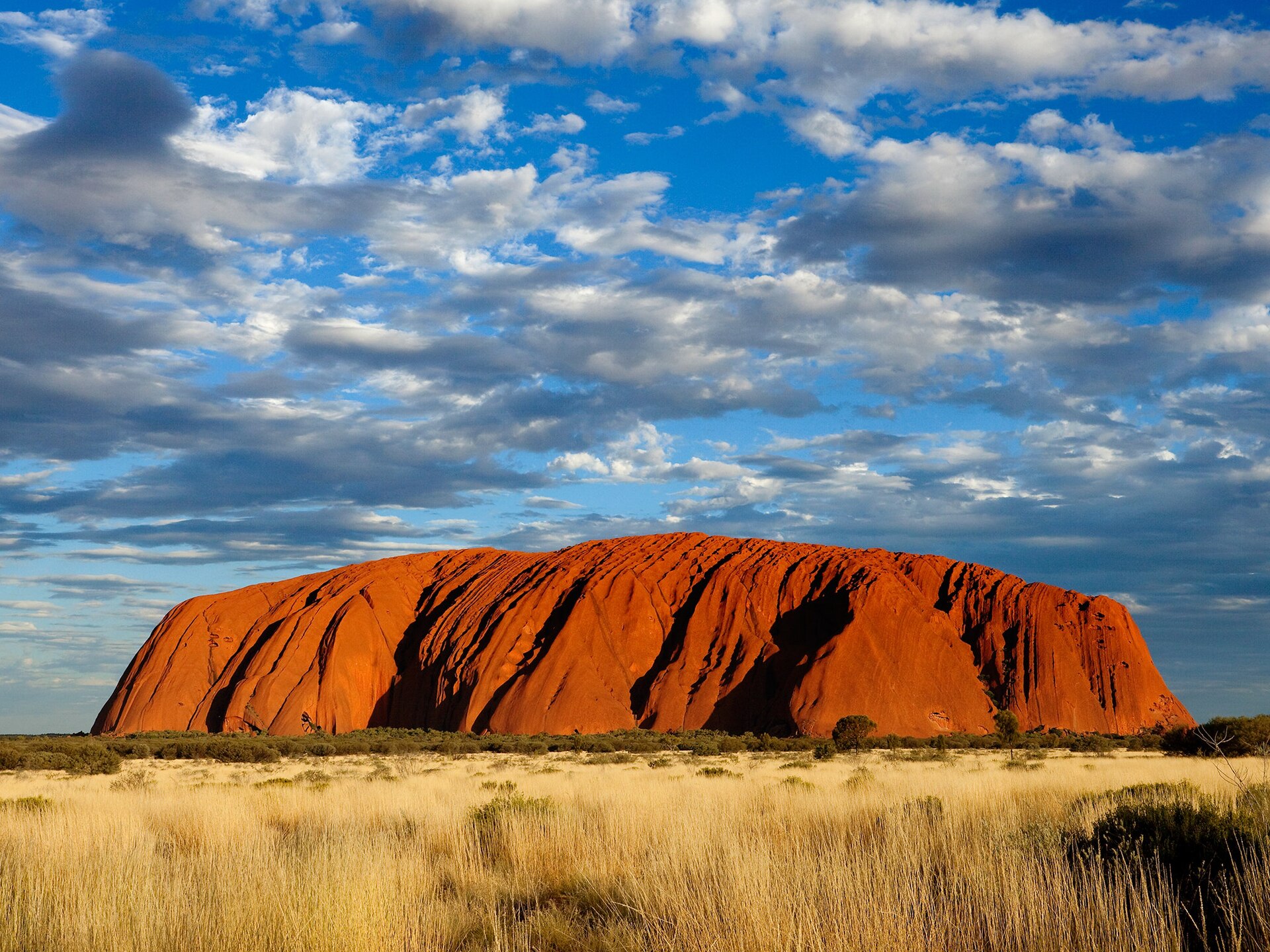 Uluru, a giant sandstone monolith rising from the central desert. A sacred site to its Aboriginal custodians, it is one of Australia's most recognisable landmarks.