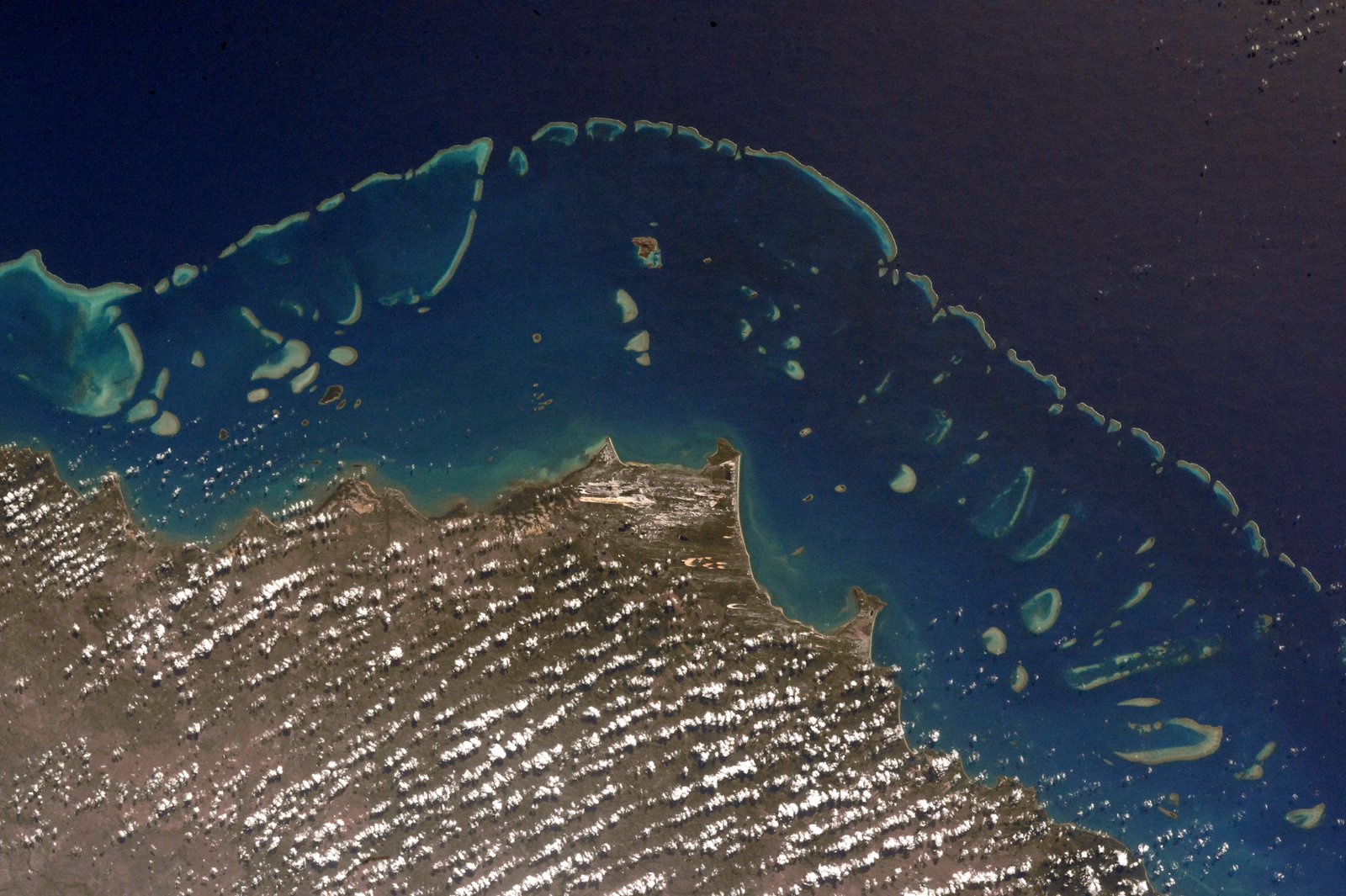 The Great Barrier Reef off the northeast coast, the largest coral reef system in the world and visible from space.