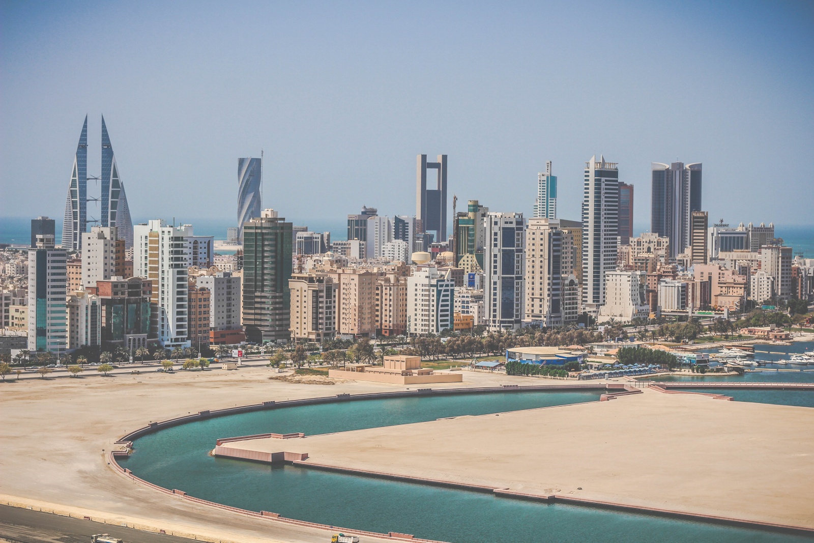 The skyline of Manama, the capital of Bahrain, rising along the Gulf. A trading crossroads for thousands of years, the city today mixes old quarters and markets with modern financial towers and reclaimed land.