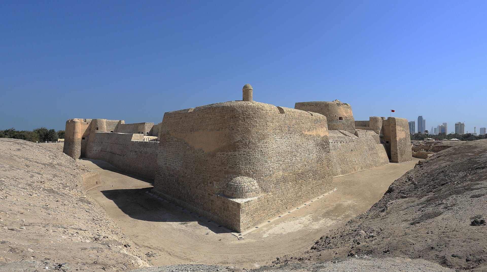 Qal'at al-Bahrain, a great mound built up over thousands of years of settlement and now a world heritage site. It was a capital of the ancient Dilmun civilisation, the Bronze Age trading power at the heart of Bahrain's deep history.
