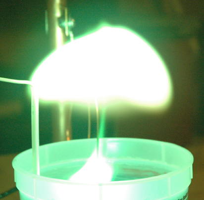 A laboratory experiment producing glowing plasma balls that mimic the phenomenon.