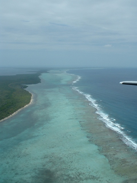 An aerial view of the Belize Barrier Reef, the longest in the Western Hemisphere and part of the great Mesoamerican reef. Its cayes, atolls, and clear waters have made Belize a world-famous destination for diving and ecotourism.