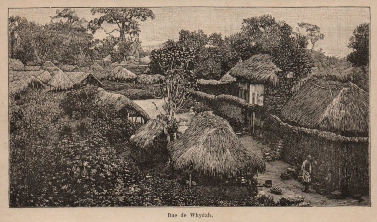 A street in Ouidah in 1892, on the eve of the French conquest. The town's mixed population included the Agudá, descendants of Brazilian traders and of formerly enslaved people who returned from Brazil, whose Portuguese surnames and Brazilian-style houses survive there still.