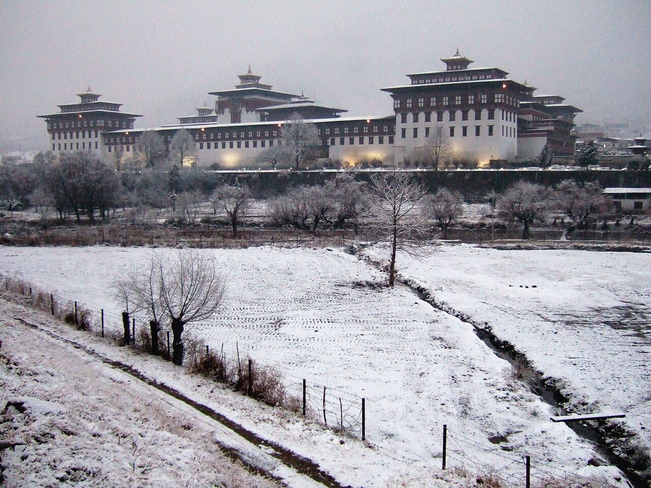 The Tashichho Dzong in Thimphu, the fortress-monastery that houses Bhutan's government and central monastic body. Its courtyards host the great religious festivals that are the highlights of Bhutanese life.