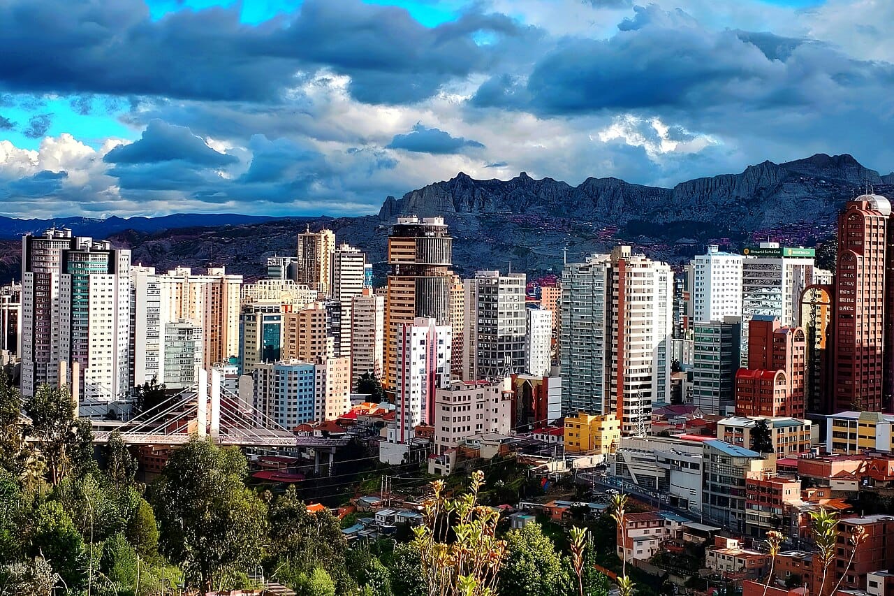 The city of La Paz, spilling down a dramatic canyon on the high Altiplano. The highest seat of government of any country in the world, it is the bustling political heart of Bolivia, ringed by the snow peaks of the Andes.