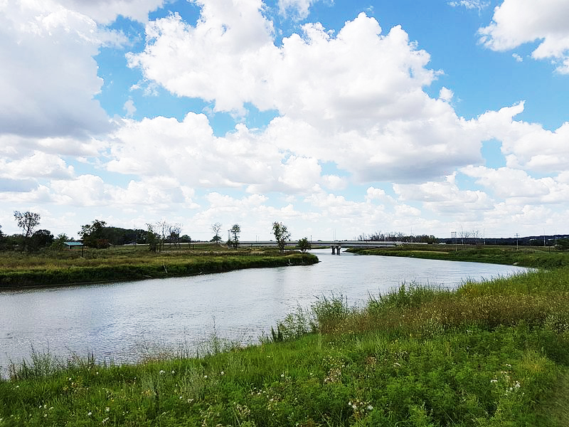 The Assiniboine River winding through Brandon. The city grew on its banks, and the river valley remains a green corridor of parks and trails through the prairie city.