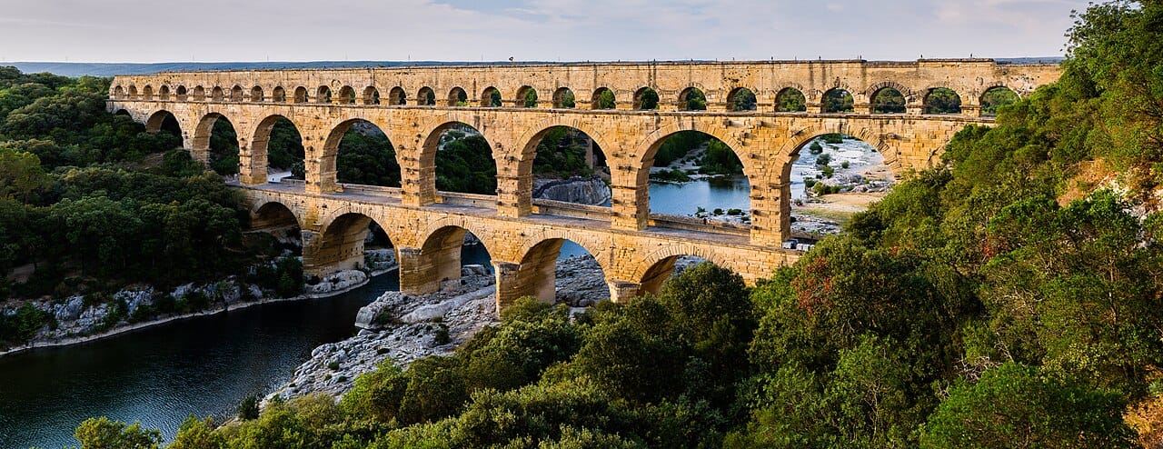 The Pont du Gard in southern France, built in the first century. An arch carries load in compression only, which is what allowed the Romans to span substantial gaps in stone.