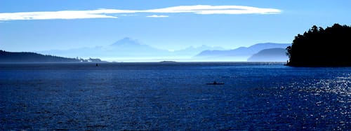 The Strait of Georgia between Vancouver Island and the mainland. The mild, island-sheltered southwest coast, where most British Columbians live, is the populous heart of the province.