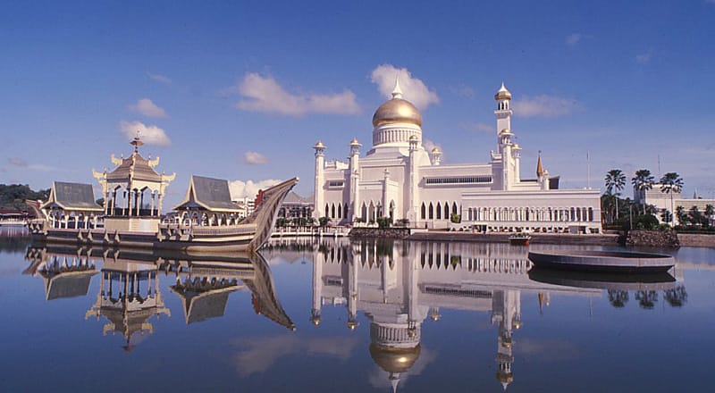 The Sultan Omar Ali Saifuddien Mosque in the capital, Bandar Seri Begawan, with its golden dome and ceremonial stone barge on the lagoon. Its splendour reflects the central place of Islam in the life of the sultanate.