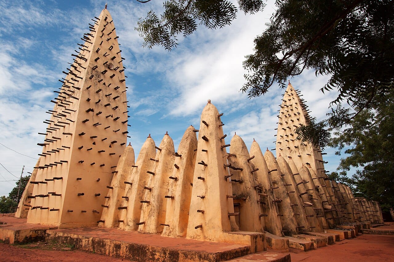 The Grand Mosque of Bobo-Dioulasso, a masterpiece of Sahelian mud-brick architecture with its bristling wooden support beams. Burkina Faso is a religiously mixed country long noted for tolerance among Muslims, Christians, and followers of traditional faiths.