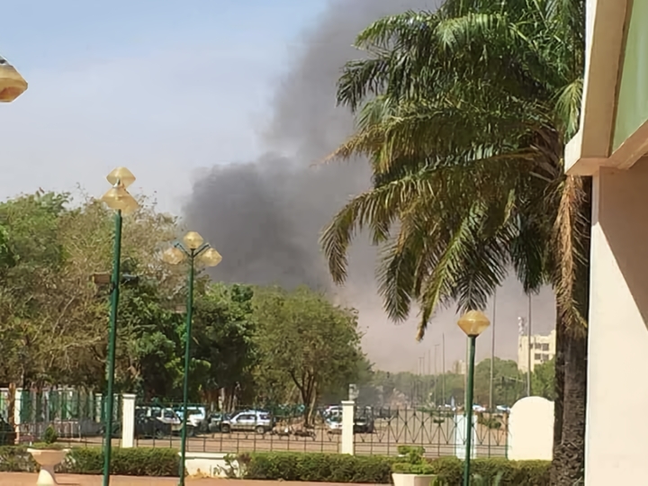 Smoke rising over Ouagadougou during a 2018 jihadist attack on the French embassy and the army headquarters. Such assaults reaching the heart of the capital underscored a security crisis that would soon topple the elected government.