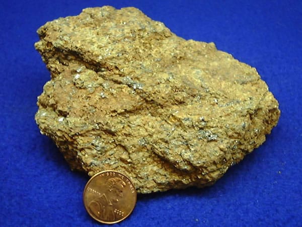 Graphite ore. The same element, bonded in sheets rather than a lattice, is soft enough to leave a mark on paper and conducts electricity along the layers.