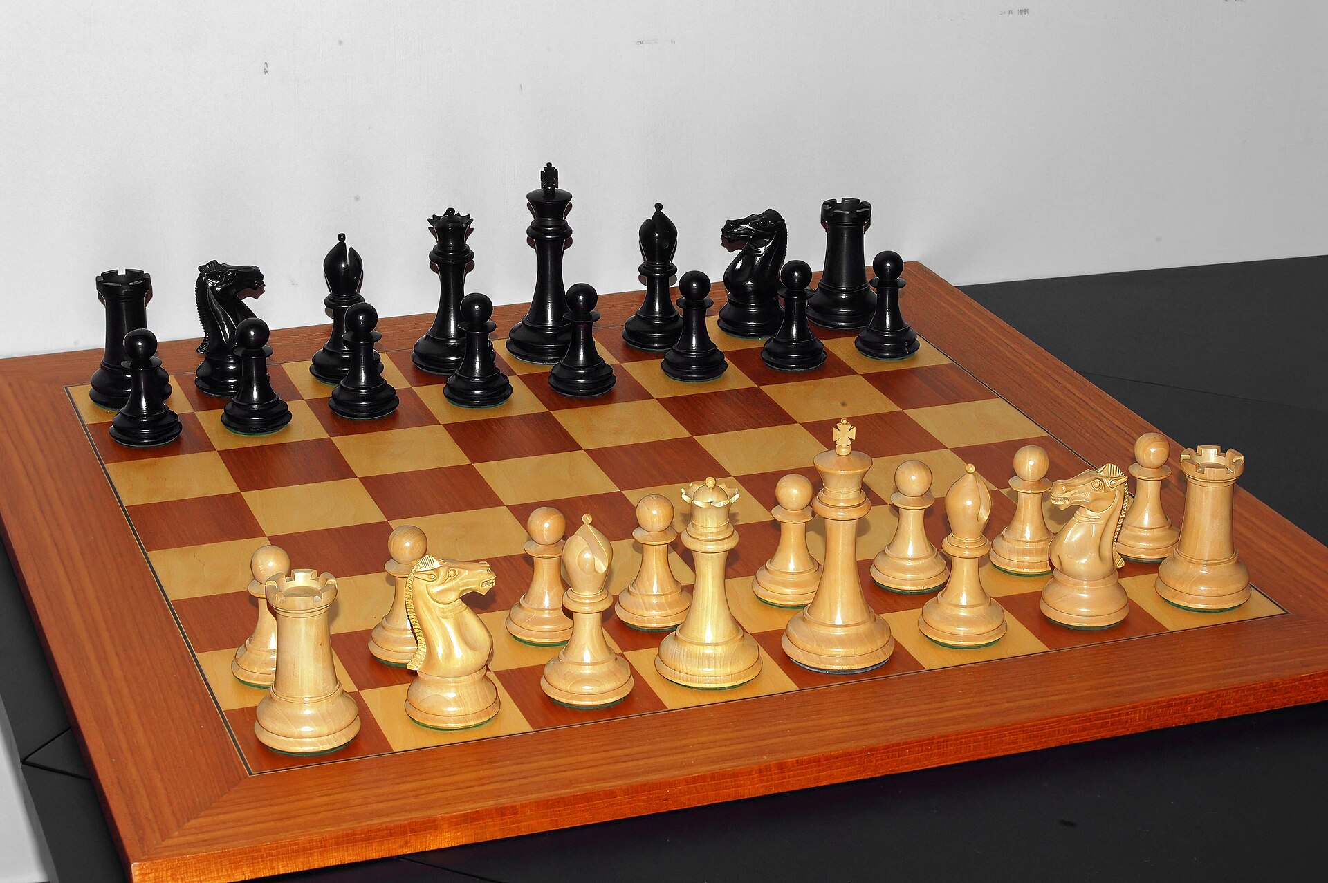 The starting position of a chess game, with the pieces set for battle.
