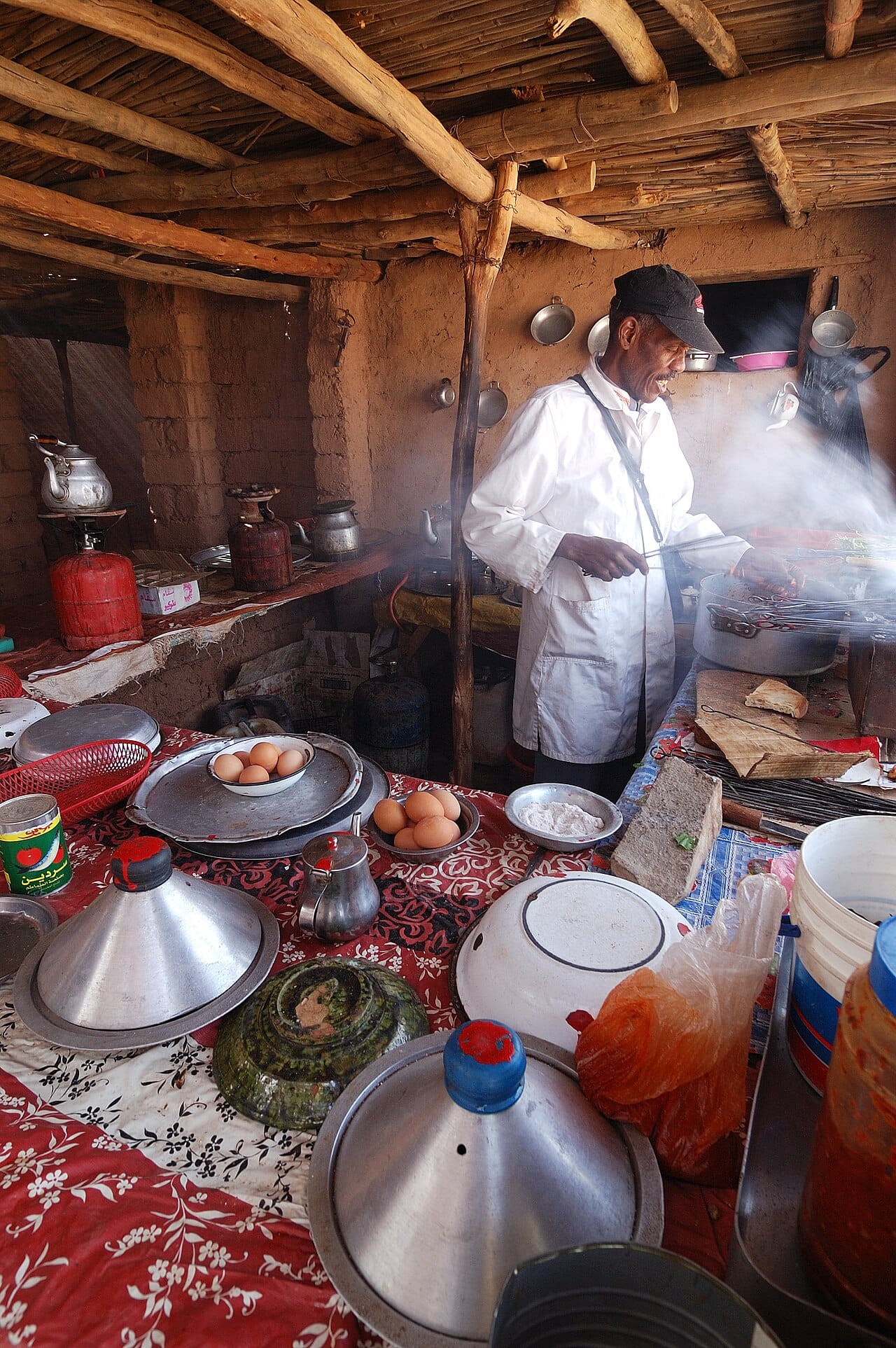 Cooking over an open fire. Heat performs part of digestion outside the body, raising the energy actually extracted from food and reducing the effort of chewing it.