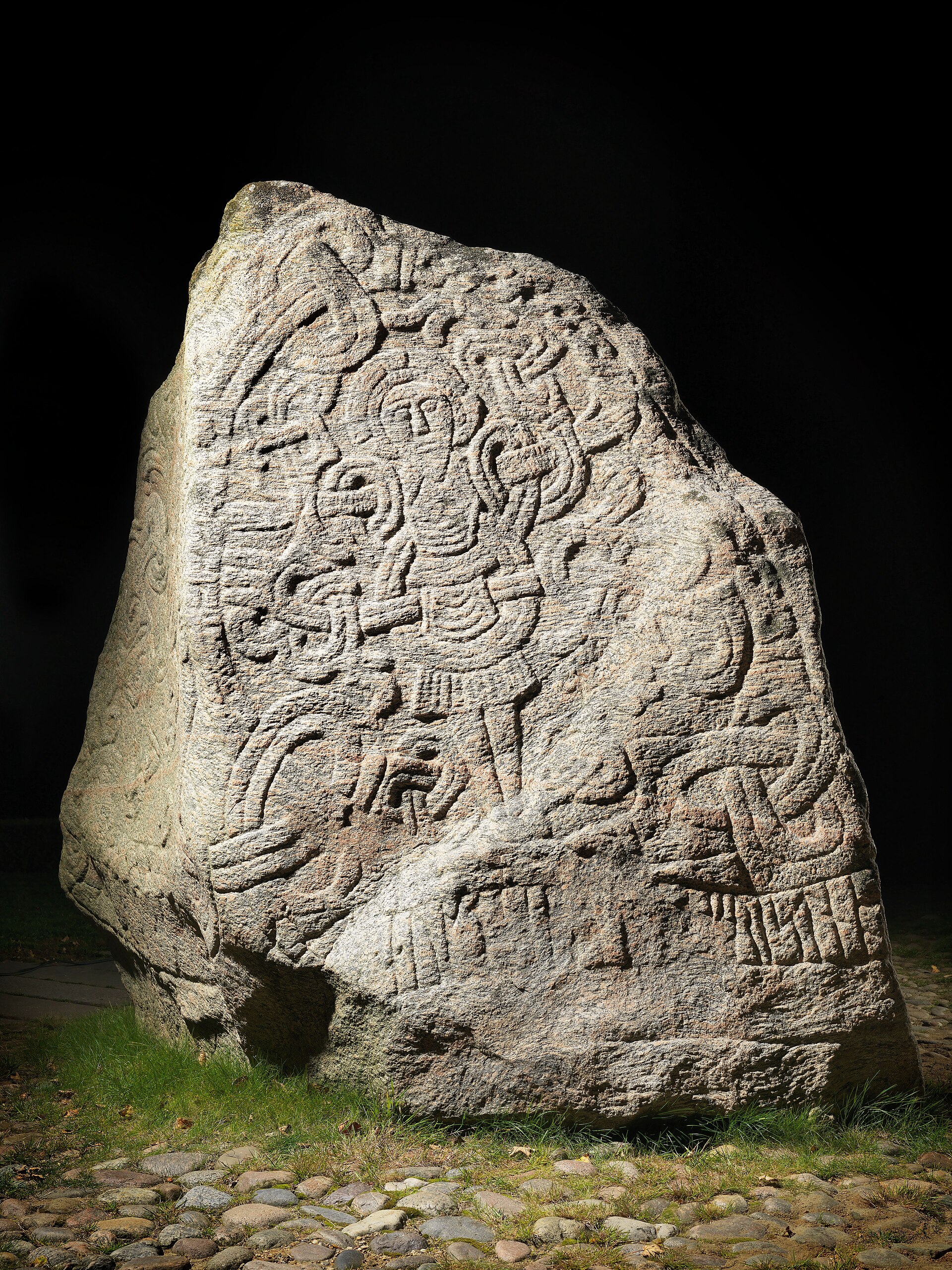 The larger Jelling stone, raised by King Harald Bluetooth, often called the birth certificate of Denmark. Credit: Photographer Roberto Fortuna, commisioned by the Danish National Museum (CC BY-SA 3.0).