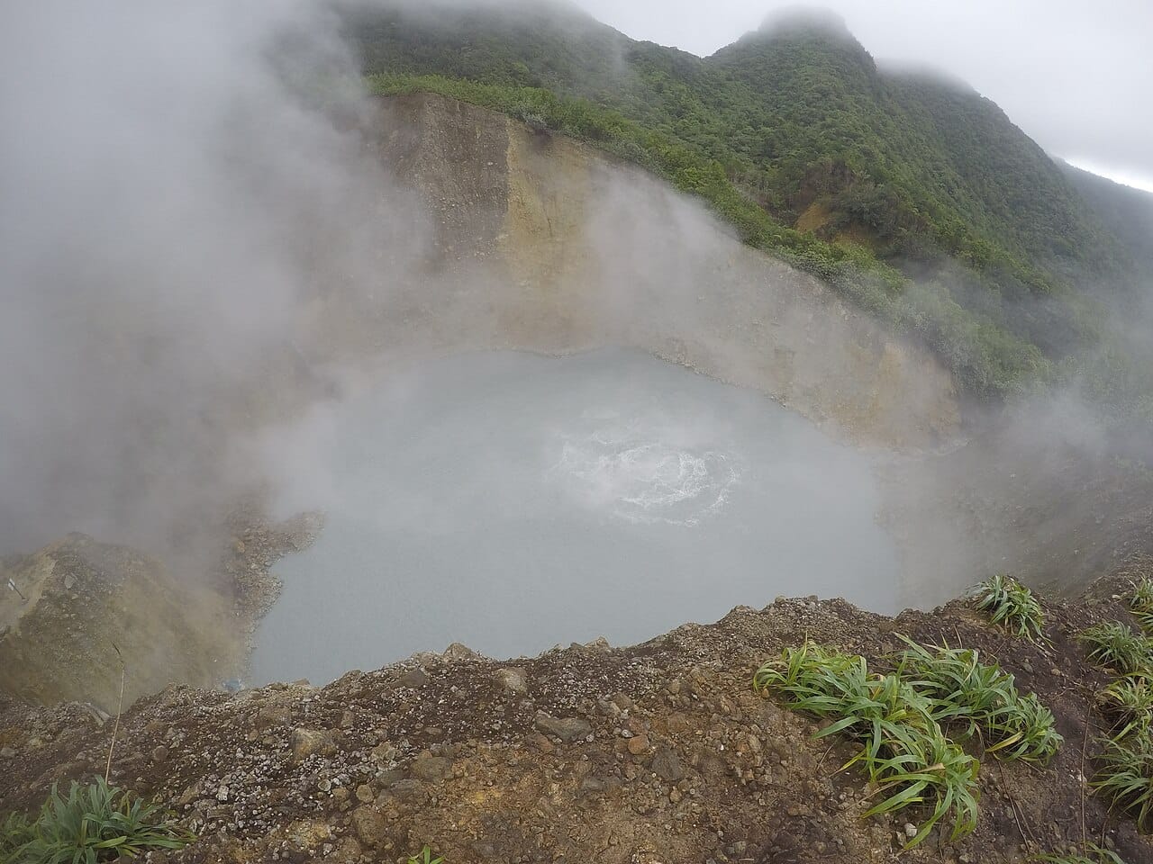 The Boiling Lake, a flooded fumarole of grey churning water reached only by a hard six-hour walk through the Valley of Desolation. It is among the largest features of its kind in the world.