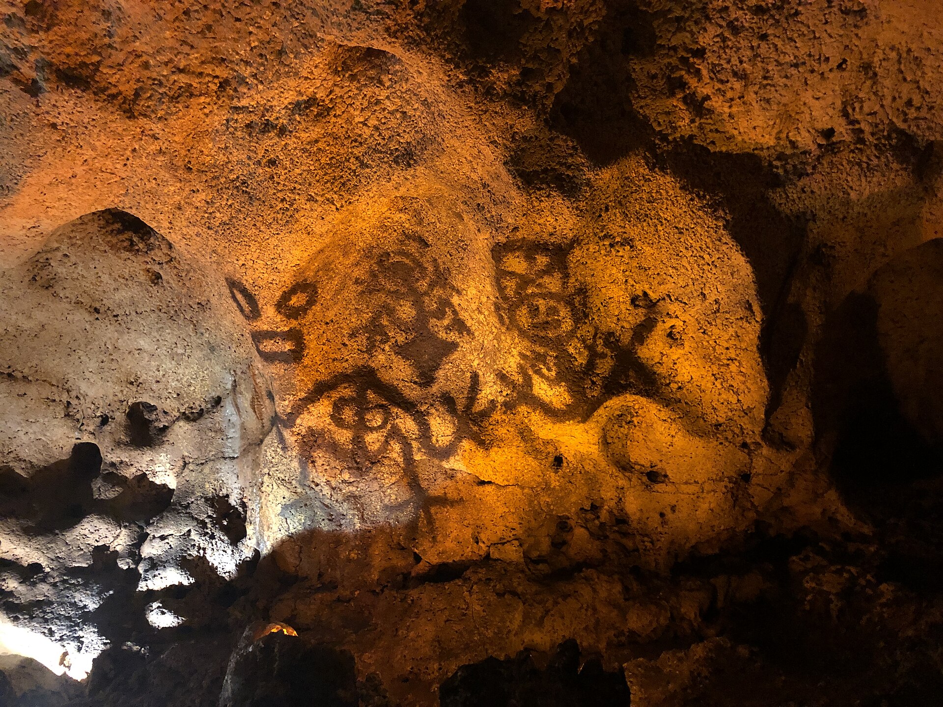 Taino pictographs in the Cueva de las Maravillas. The carvings and words of the island's first people survive in caves and in the Dominican tongue, long after the Taino themselves were gone.
