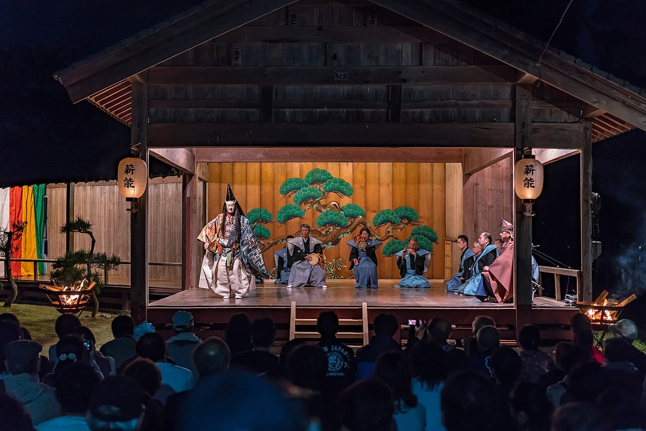 A Noh performance. The Japanese tradition, formalised in the fourteenth century, uses masks, stylised movement and a repertoire performed continuously for six centuries.