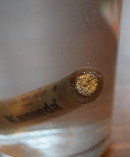 Electrolysis of salt water using an ordinary battery, with gas collecting at the electrodes. The reaction runs only while current flows, which is what distinguishes it from spontaneous chemistry.