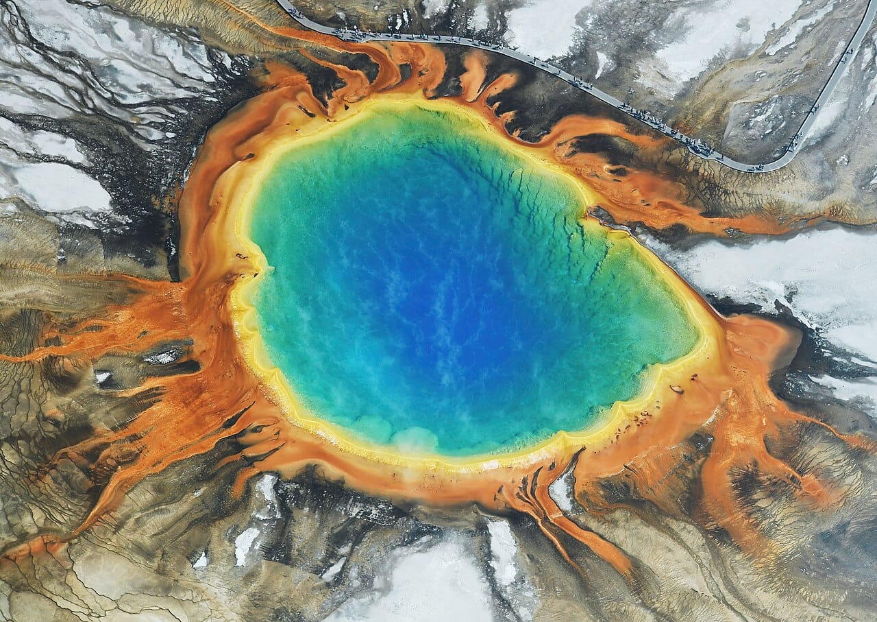 The Grand Prismatic Spring in Yellowstone. The colours are produced by mats of microorganisms, each thriving in a different temperature band as the water cools outward from the centre.