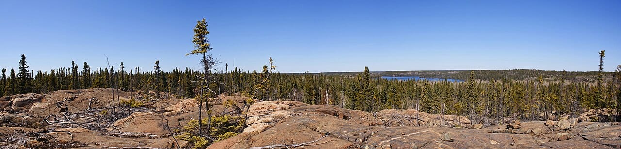 Rock outcrop and boreal wilderness at the edge of town. The Canadian Shield here is among the most heavily glaciated terrain in North America.