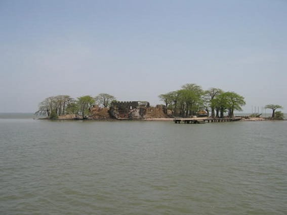 The Gambia River near the island fort, now called Kunta Kinteh Island, once a collection point of the Atlantic slave trade. It became famous through Roots, which traced one African American family's ancestry to a captive taken from here.