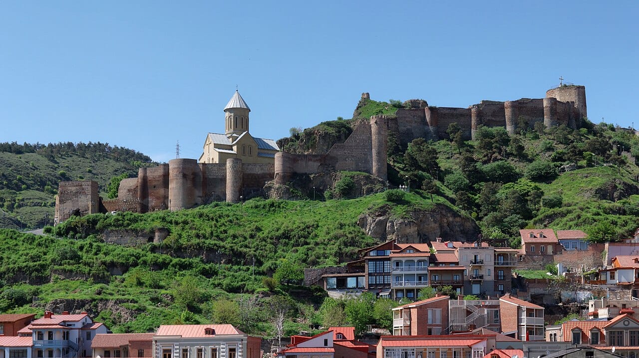 The ancient Narikala fortress overlooking the old town of Tbilisi, its walls first raised more than a thousand years ago. The capital grew up around the hot springs below it, sheltered on the hills of the Kura valley.