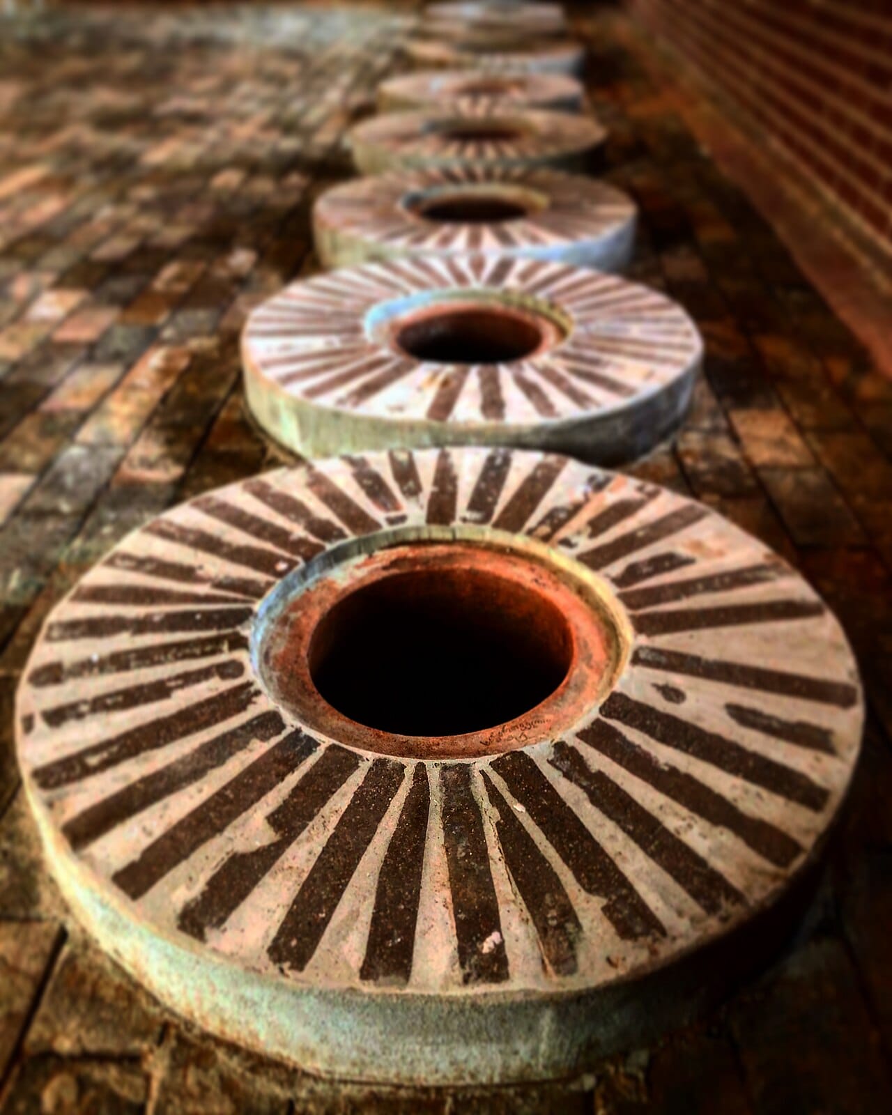 The mouths of qvevri, large earthenware vessels buried in the ground of a Georgian cellar to ferment and age wine. This ancient method, reaching back some eight thousand years, is recognised by UNESCO and lies at the heart of Georgia's claim to be the birthplace of wine.