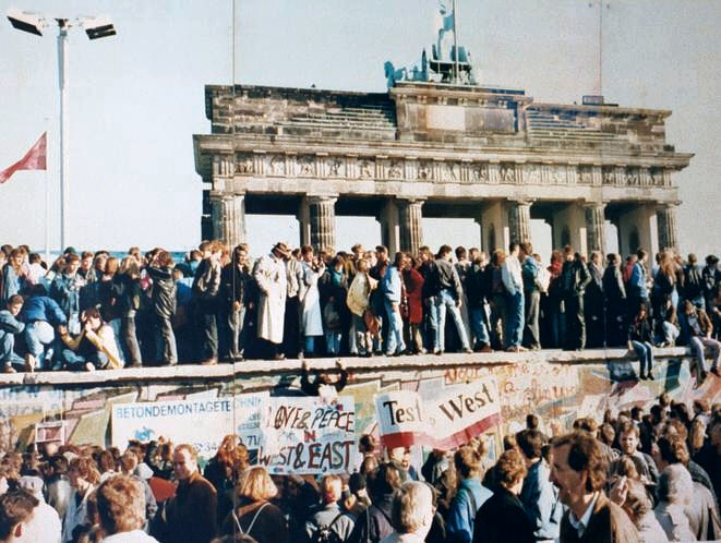 The fall of the Berlin Wall in 1989, which led to the reunification of a divided Germany. Credit: Unknown photographer, Reproduction by Lear 21 at English Wikipedia. (CC BY-SA 3.0).