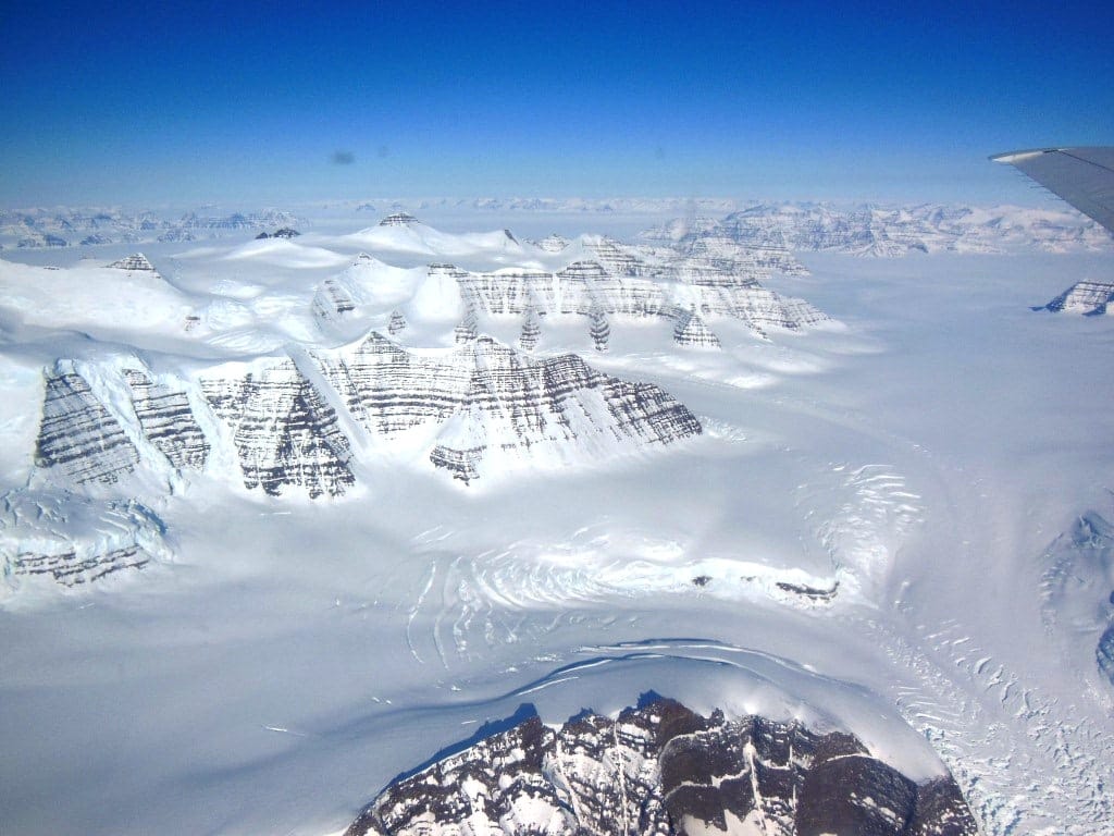 A polar glacier. Ice sheets and ice caps cover the underlying terrain entirely, whereas valley glaciers are confined by the landscape they flow through.