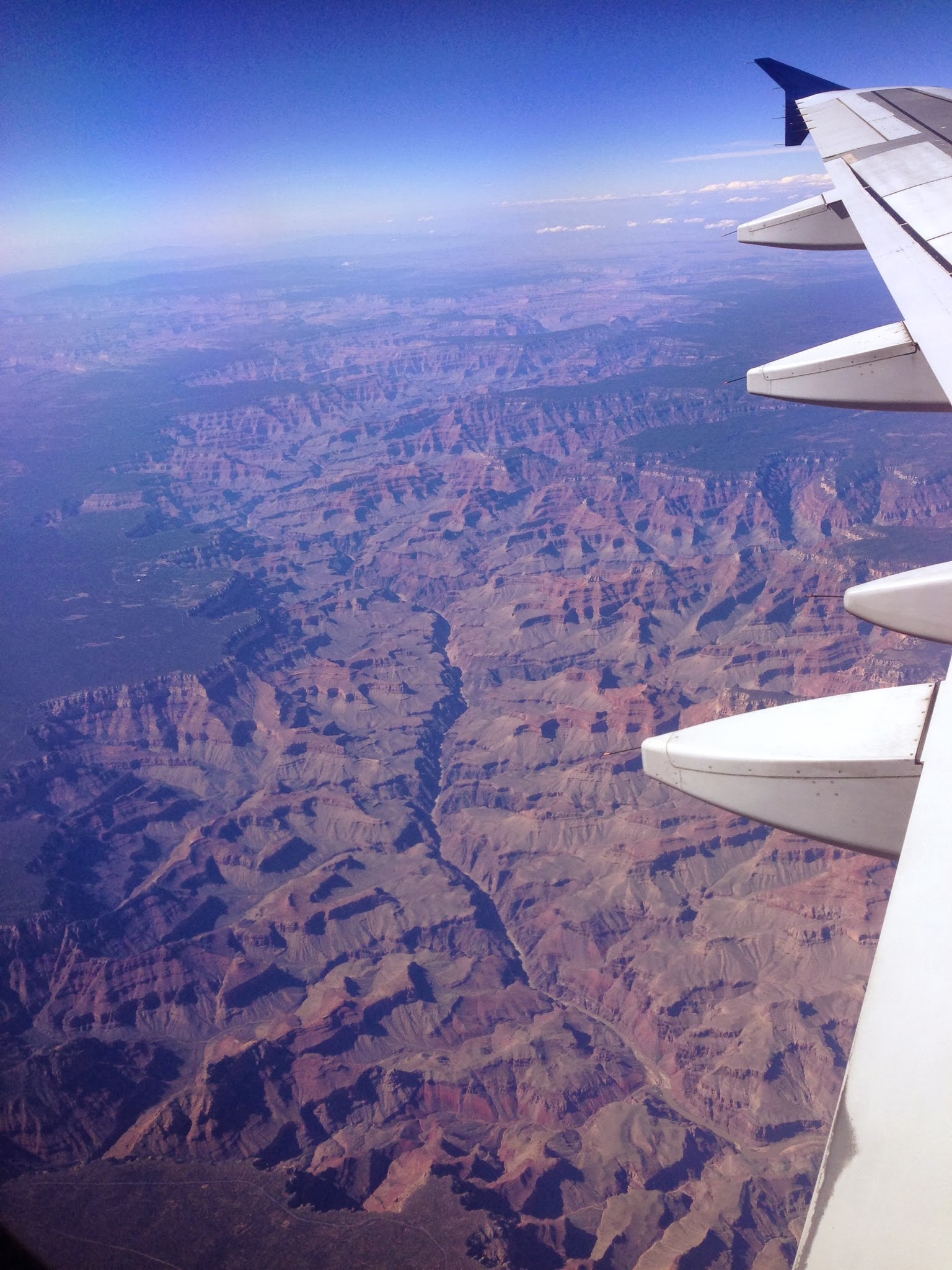 The Grand Canyon from the air, with the Colorado River, the force that carved it, winding along the bottom. Credit: Runner1928 at English Wikipedia (CC BY-SA 3.0).