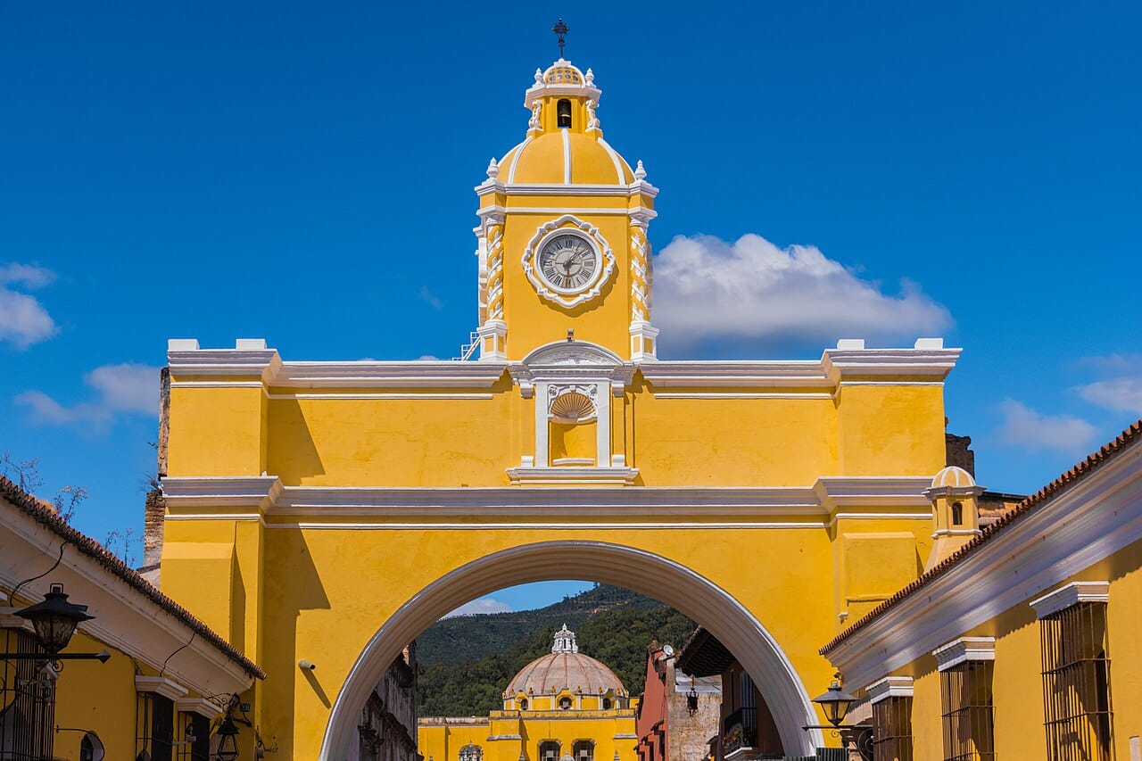 The colonial arch of the old capital, Antigua Guatemala, framing a volcano beyond. A World Heritage site of cobbled streets and baroque churches ringed by volcanoes, Antigua preserves the splendour of Spanish Central America.