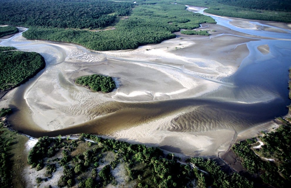 The Bijagos Archipelago, a scatter of low, mangrove-fringed islands off the coast of Guinea-Bissau, protected as a biosphere reserve. Rich in wildlife, including rare saltwater hippos, the maze of creeks has also served smugglers well.