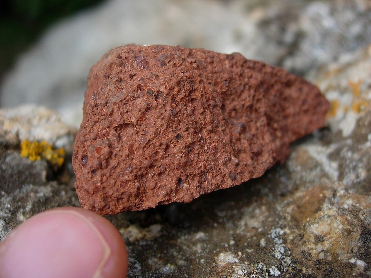 Bauxite, the reddish ore from which aluminium is refined. Guinea sits on some of the largest reserves in the world and is a leading exporter, a mineral wealth that has yet to lift most of its people out of poverty.