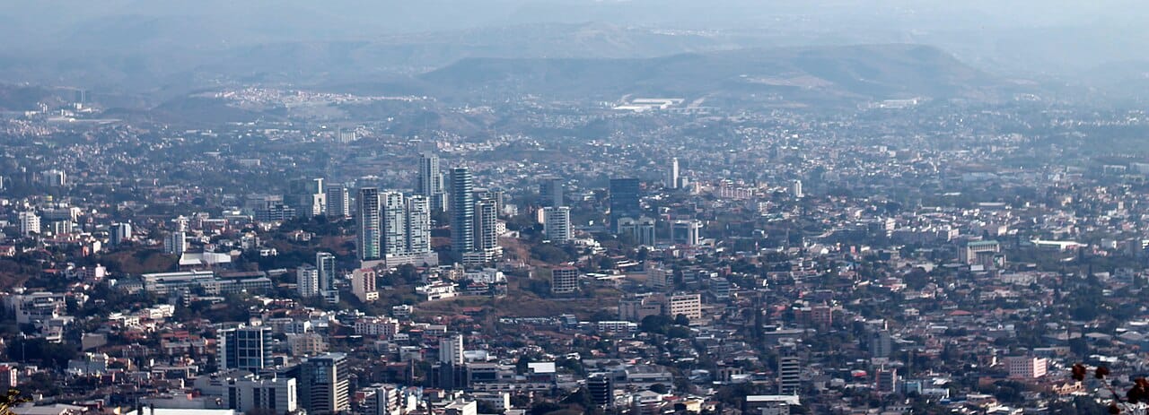 Tegucigalpa, the capital of Honduras, spread across a bowl of mountains. Never linked to the railways that served the banana coast, the highland capital grew into the crowded political and economic centre of the nation.