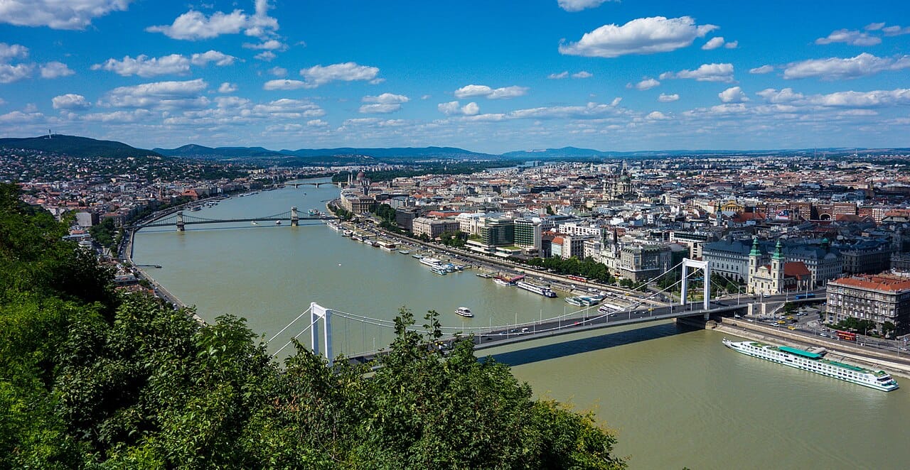 Budapest, the capital of Hungary, straddling the Danube that divides hilly Buda from flat Pest. A grand city of bridges, baths, and boulevards, it is home to a large share of the nation and the heart of its cultural and political life.