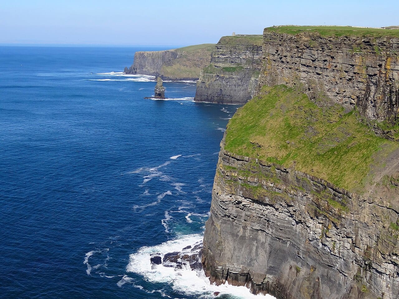 The Cliffs of Moher on the Atlantic coast of County Clare, rising sheer from the ocean. The wild western seaboard, all cliffs, inlets, and islands facing the open sea, is the most dramatic of Irish landscapes.