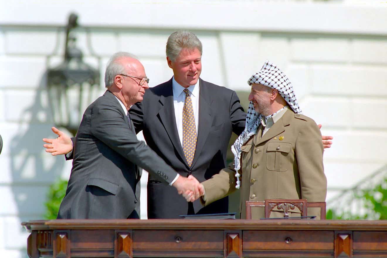 Israeli Prime Minister Yitzhak Rabin and PLO leader Yasser Arafat with United States President Bill Clinton at the signing of the Oslo Accords in 1993. The agreements set up limited Palestinian self-rule but did not bring a final peace.