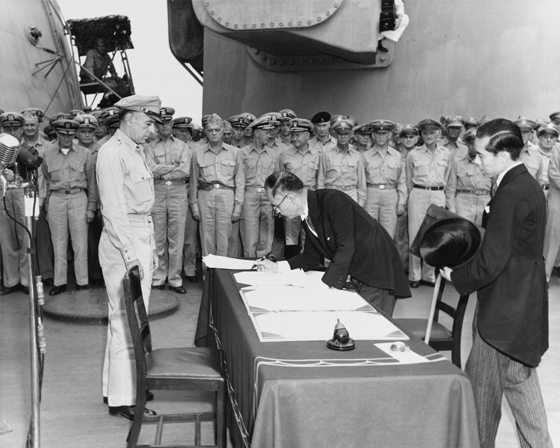 The formal Japanese surrender aboard the USS Missouri on the 2nd of September, 1945, ending the Second World War. Credit: Army Signal Corps photographer LT. Stephen E. Korpanty; restored by Adam Cuerden (Public domain).