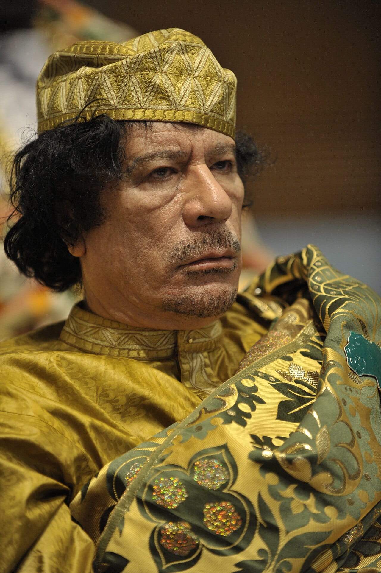 Muammar Gaddafi at an African Union summit. He took power in 1969 at the age of twenty-seven, held no formal office for most of the next forty-two years, and used Libya's oil revenue to make himself one of the most conspicuous figures in world politics.