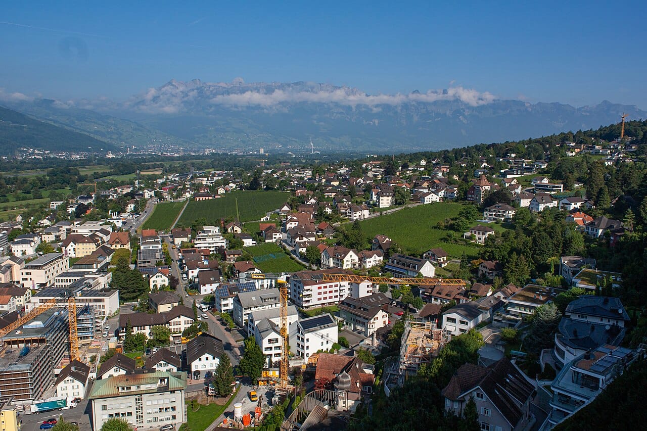 Vaduz in the Rhine valley. More than half of Liechtenstein's workforce commutes in from Switzerland and Austria each day, so the country's daytime population is considerably larger than its resident one.