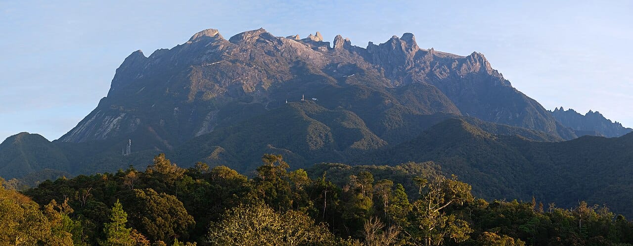 Mount Kinabalu rising above Borneo, the highest peak in Malaysia. The wilder eastern states of Sabah and Sarawak, on the island of Borneo, hold vast rainforests among the oldest and most biodiverse on Earth.