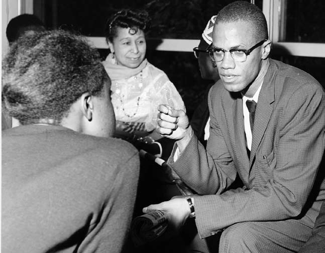 Malcolm X speaking; his powerful oratory drew large crowds.