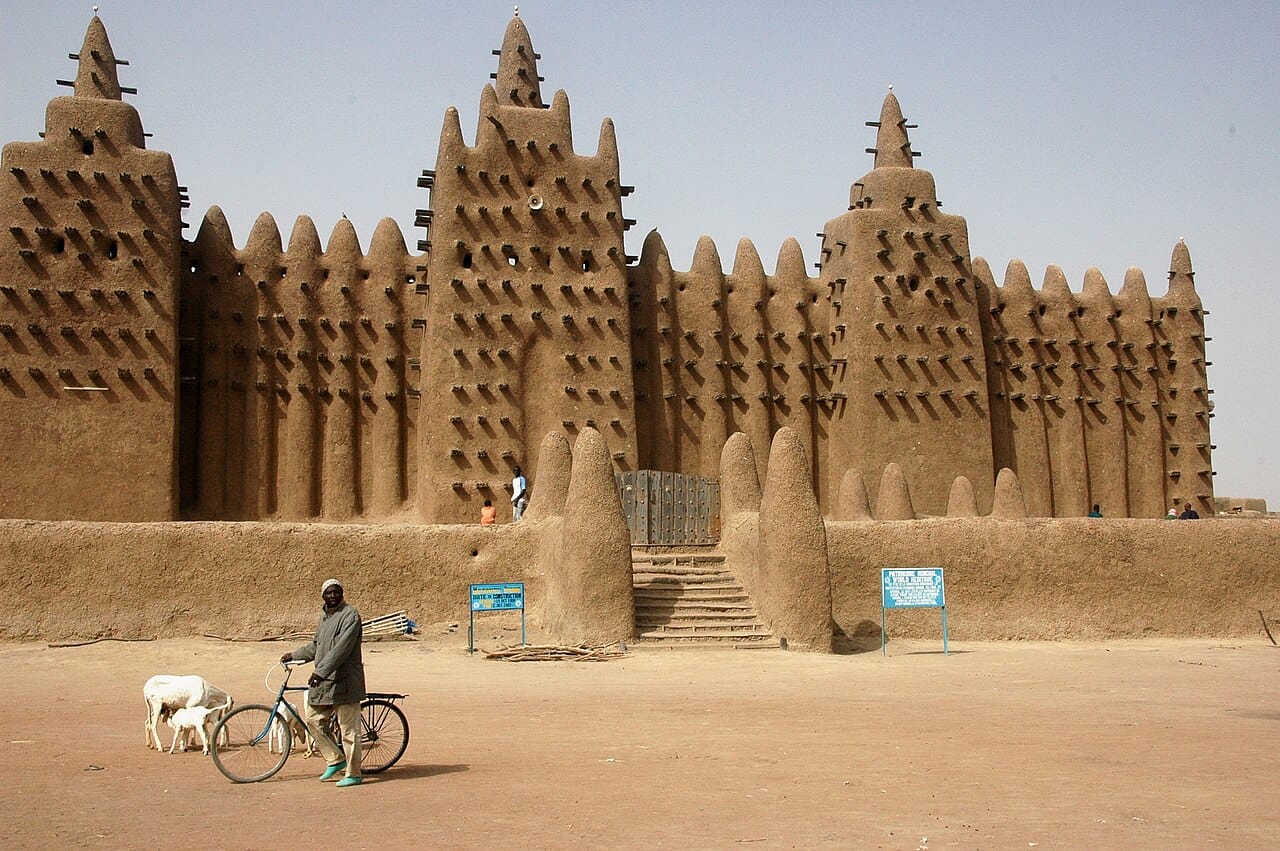 The Great Mosque of Djenne, the largest mud-brick building in the world and a masterpiece of Sahelian architecture. Rebuilt in 1907 on the site of a far older mosque, it is replastered each year by the whole community in a great festival.