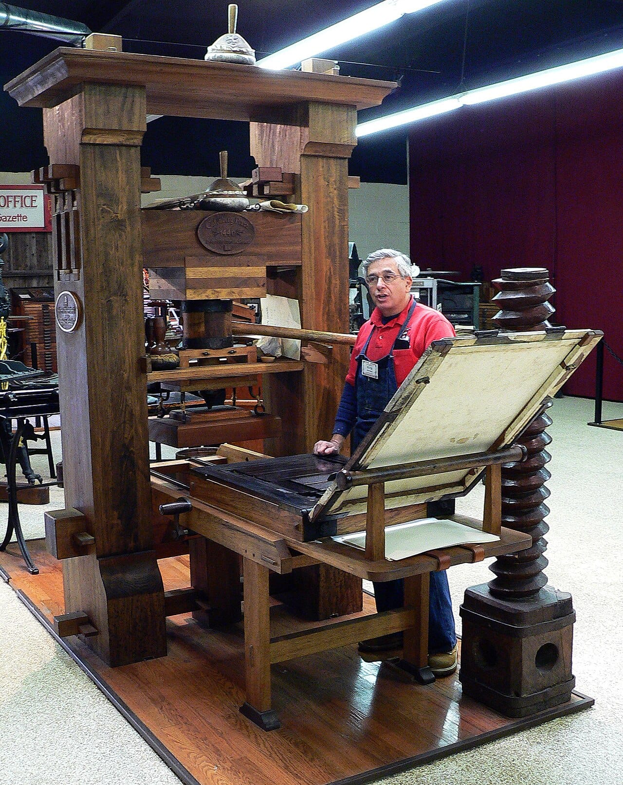A printing press. McLuhan's account of print holds that repeatable identical text produced standardisation, nationalism and the private reader, largely independently of what was printed.