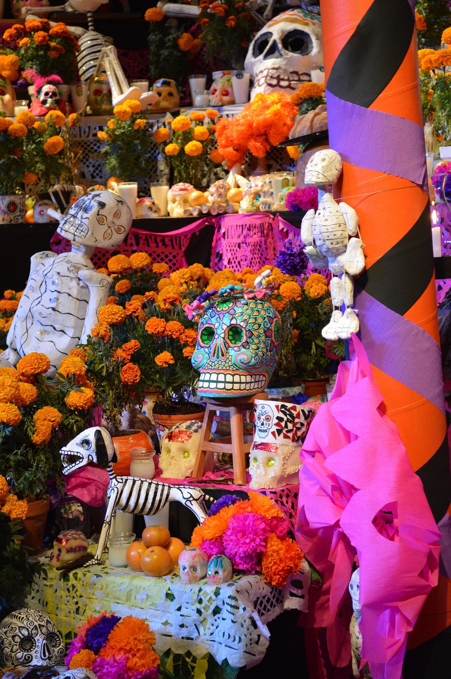 A Day of the Dead altar. On the first days of November, families honour the dead with marigolds, food, and photographs, a celebration that blends Catholic observance with pre-Hispanic belief.