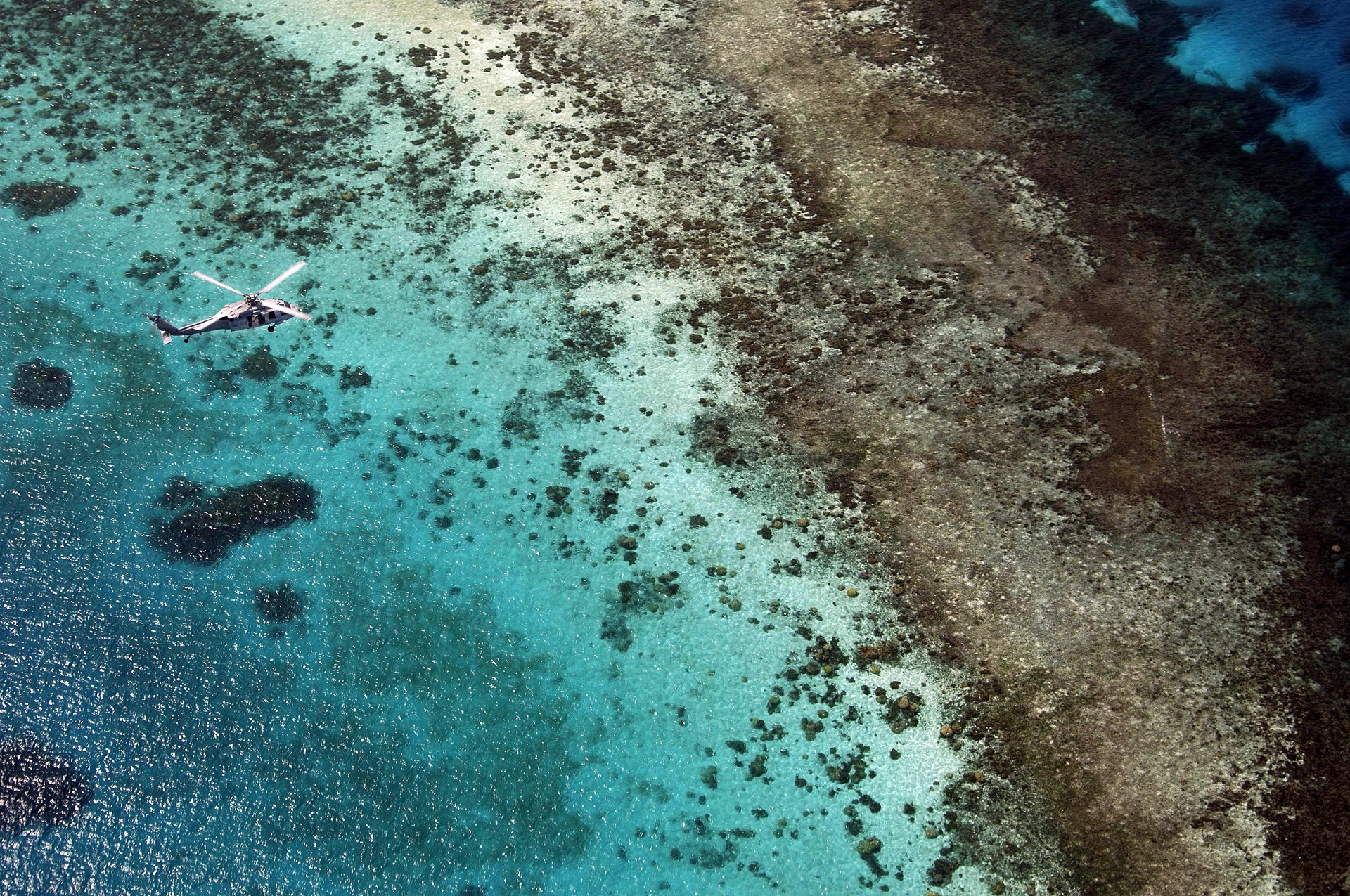 A United States Navy helicopter over the waters of Micronesia. Under the Compact of Free Association the United States is responsible for the defence of the islands, one of the closest such ties in the Pacific.